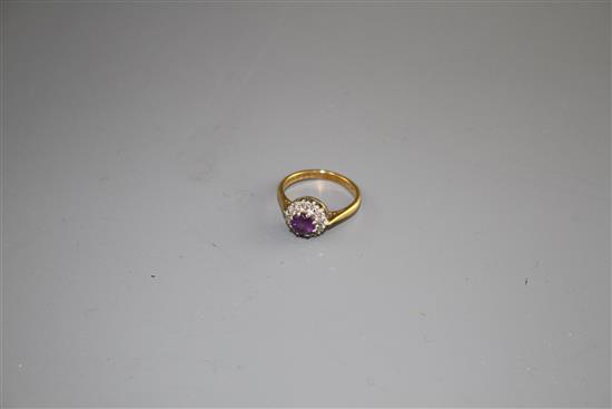 A modern 18ct gold, amethyst and diamond set circular cluster ring, size I, gross weight 3.2 grams.